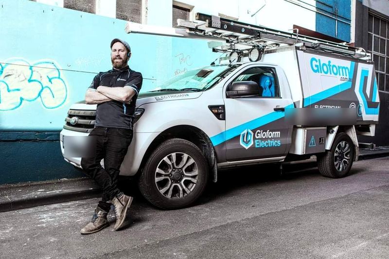 Blake standing with the Gloform Electrics van