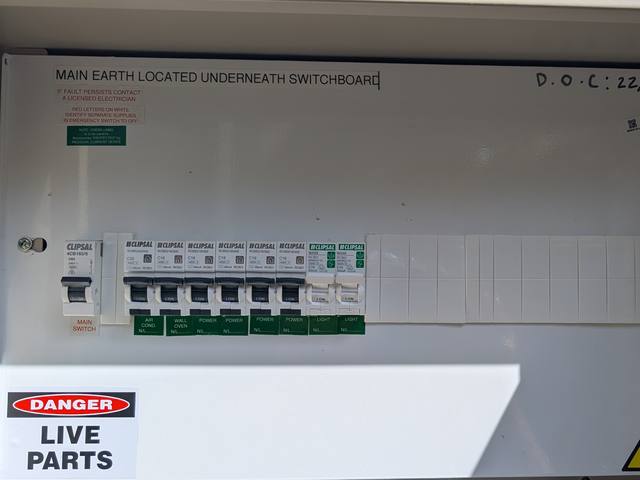 Switchboard with a main switch and a row of labelled Clipsal safety switches for power, lights, oven, and air conditioning in Frankston