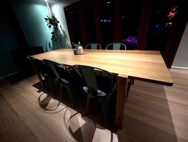 Dining table lit at night with garden lights outside